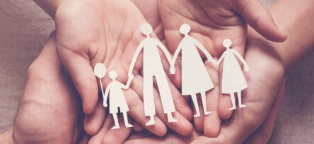 Adult and children hands holding paper family cutout, family home, adoption, foster care, homeless support, family mental health, autism support, domestic violence concept